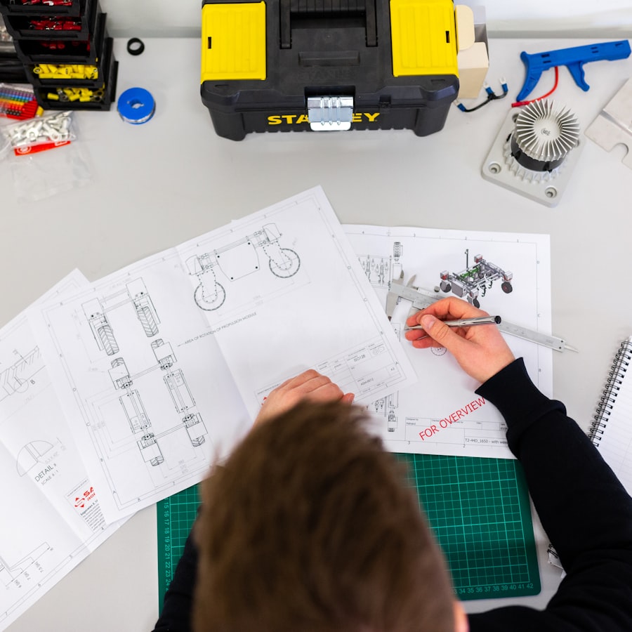 An engineer checking dimensions with calipers over technical drawings