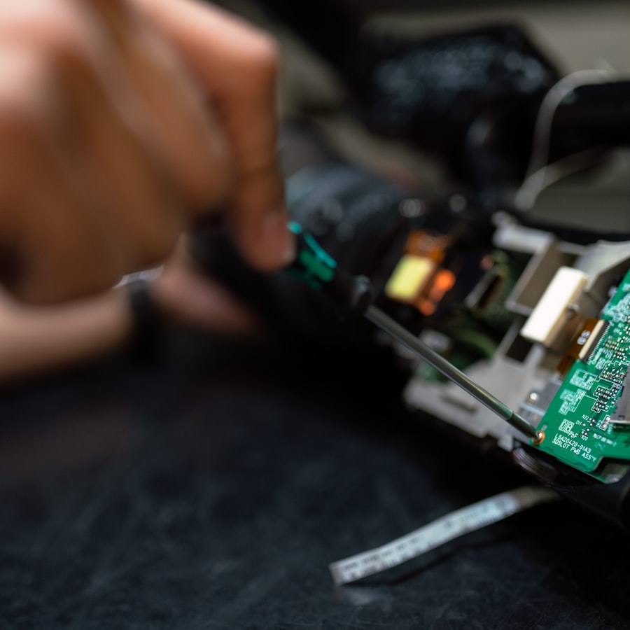 A technician adjusting a circuit board with a screwdriver