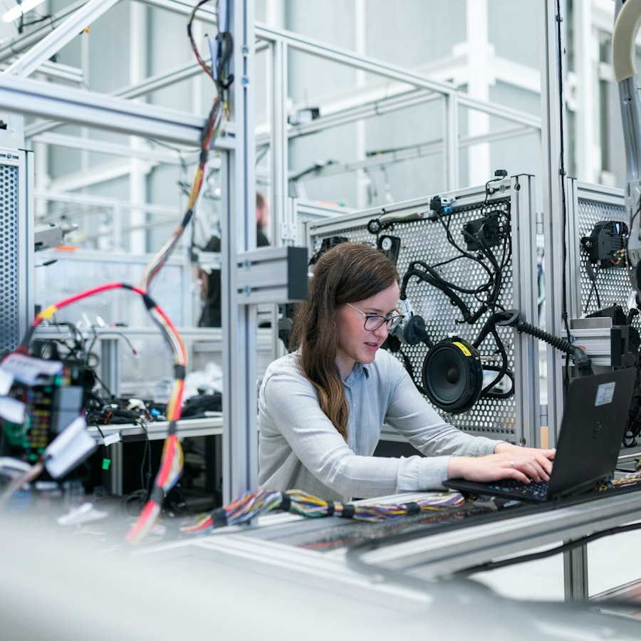 An engineer working on a laptop at a component test rig
